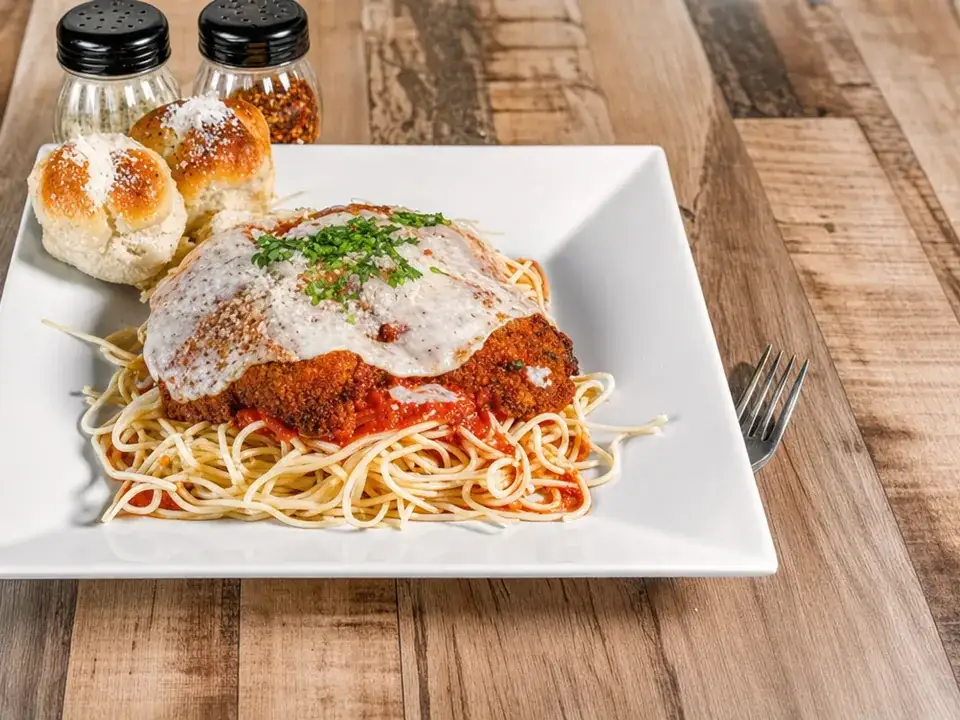 Chicken Parmigiana served over pasta