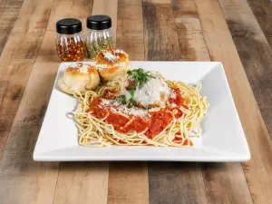 Meatballs Parmigiana served over pasta