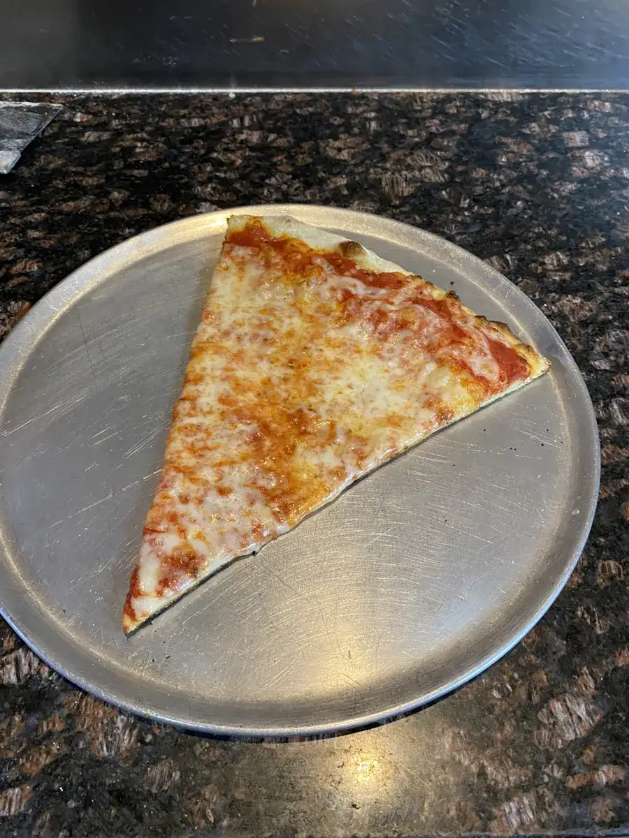 Cheese New York-style slice on a metal pizza tray