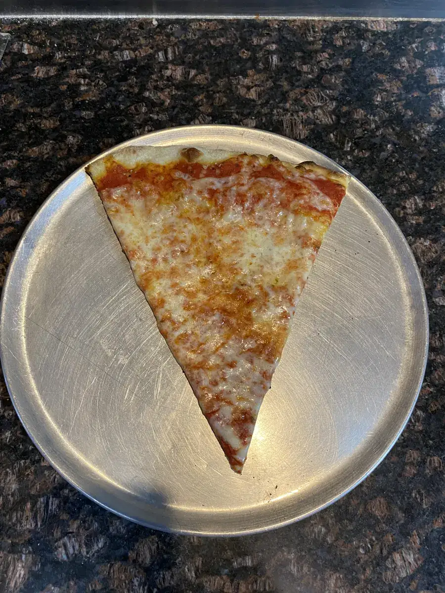 New York-style cheese slice on a metal pizza tray