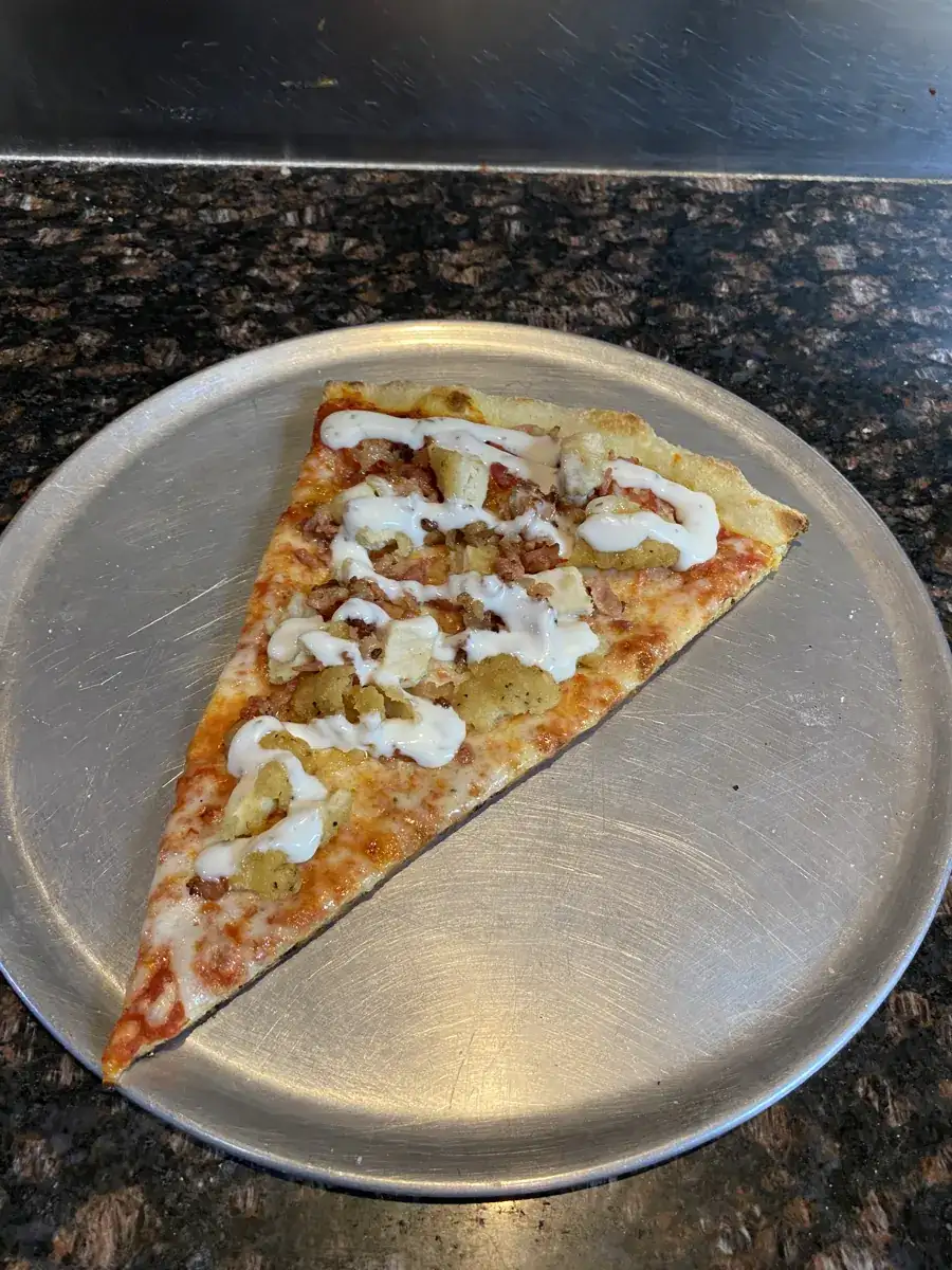 Chicken Bacon Ranch New York-style slice on a metal pizza tray