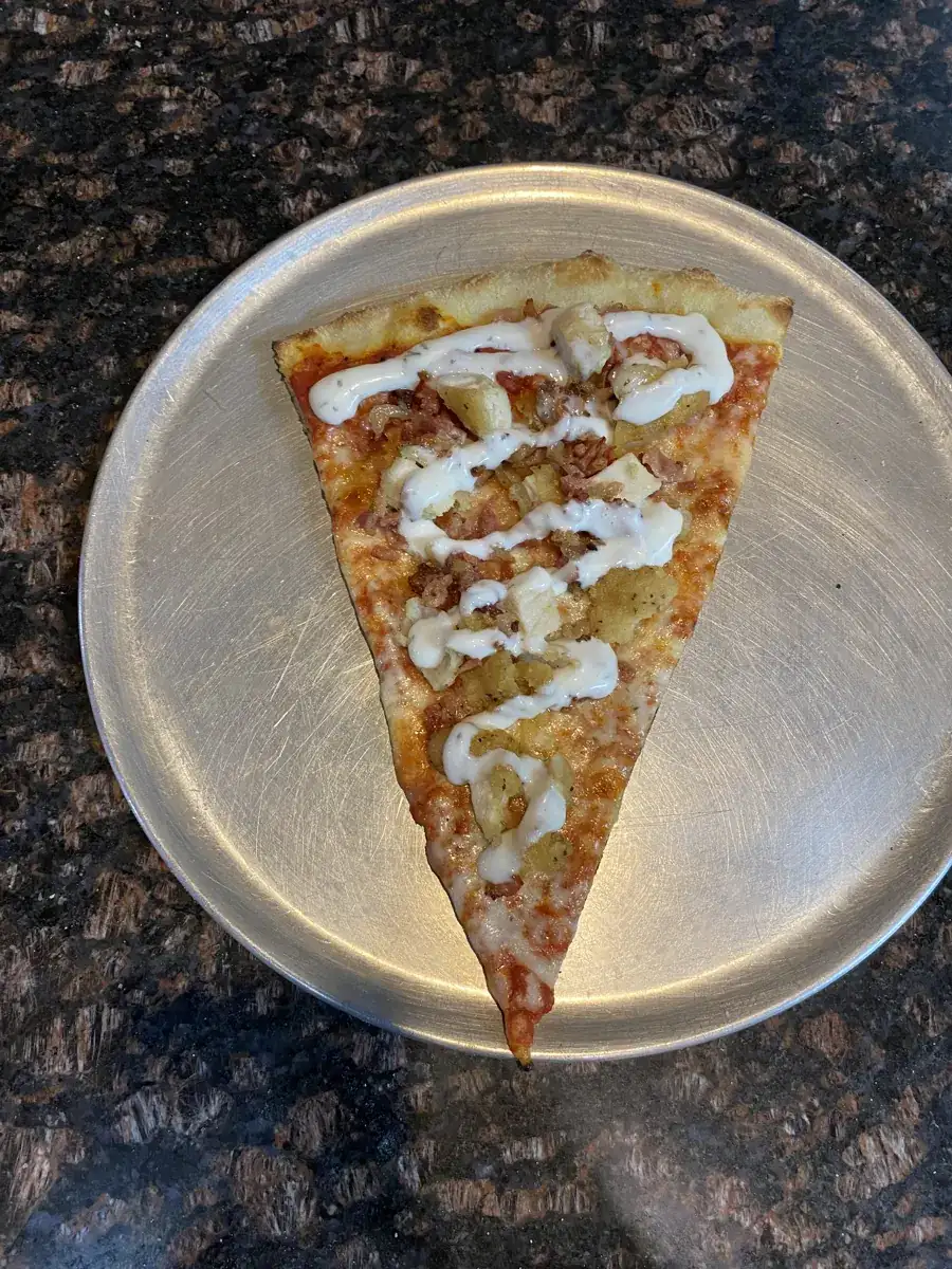 Chicken Bacon Ranch New York-style slice on a metal pizza tray