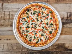 Veggies Delight pizza with tomatoes, onions, mushrooms, spinach, and eggplant