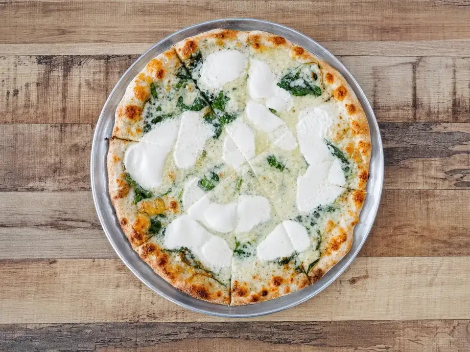 White Pie pizza with ricotta, mozzarella, and spinach